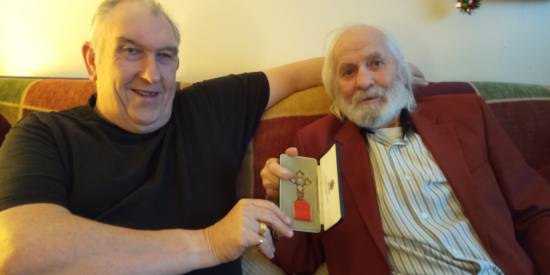 Rockin Johnny showing Dell his MBE